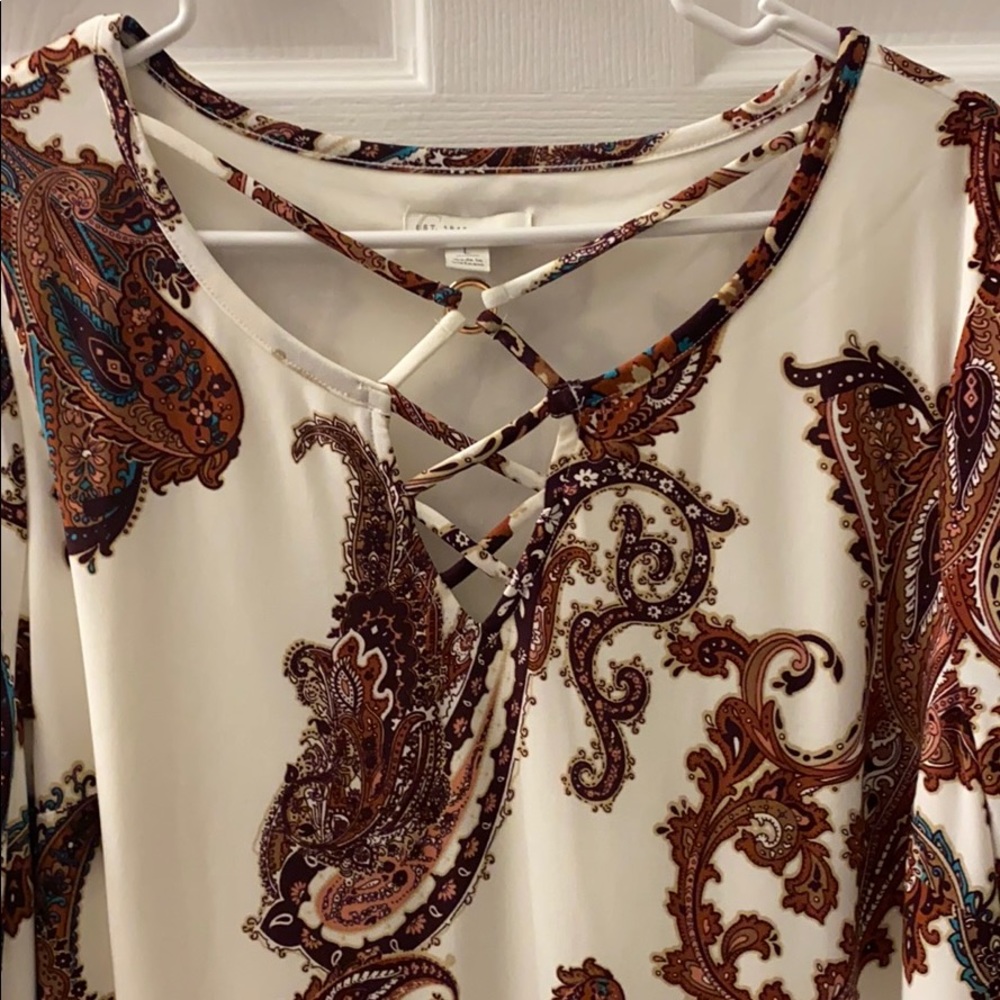 A 3/4 sleeve dress that is paisley printed